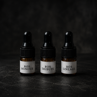 Three small brown bottles with droppers labeled 'ROS Honour', 'ROS Tribute', and 'ROS Lineage' on a dark background.